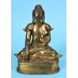 A Burmese gilt bronze Buddha, seated, wearing monastic robes, 25 cm high See illustration Report