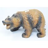 A Black Forest style carved wood grizzly bear, 38 cm wide