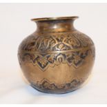 An Islamic brass vessel, of compressed baluster form, decorated foliage and calligraphy, 9 cm high