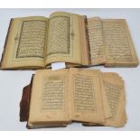 A Mughal book, bound in leather, binding poor, pages loose, and two other Mughal volumes (sold