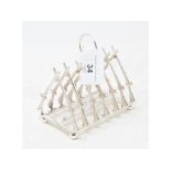 A plated toast rack, in the form of crossed guns, 11.5 cm high Report by RB Modern