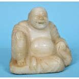 A Chinese carved alabaster figure, of the laughing Buddha, 16.5 cm high See illustration