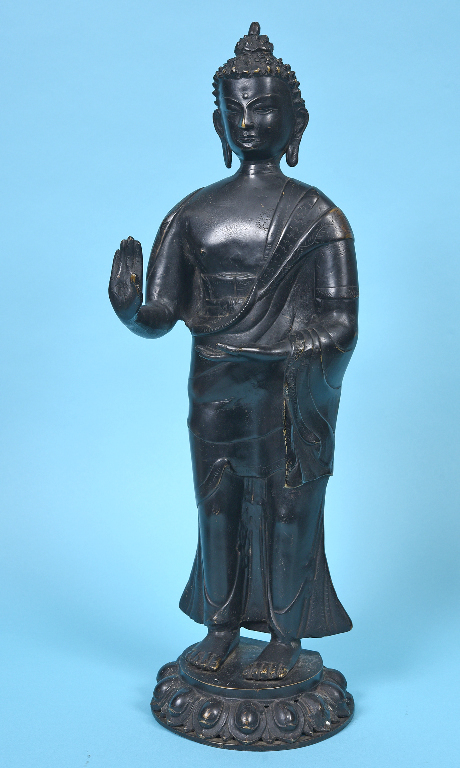 A large Nepalese Buddha, standing, on a lotus leaf base, 55 cm high See inside front cover colour