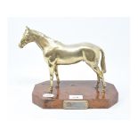 An Italian gilt metal model of a race horse, on a burr wood plinth, having a plaque engraved A.N.A.