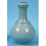 A Chinese celadon ground vase of baluster form, moulded lotus leaves, six character mark in