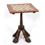 A chess table, with ivory inlay, on zebra legs, 54.5 cm wide See illustration