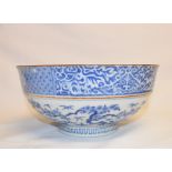 A Chinese porcelain bowl, decorated a figure and foliage, 22 cm diameter