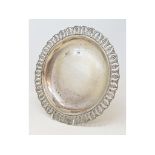 A silver coloured metal dish, the border pierced palmettes, anthemions and acanthus leaves, 29.5