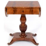A 19th century German mahogany drop leaf table, having a frieze drawer, on a turned and reeded