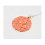 A coral pendant, carved flowers