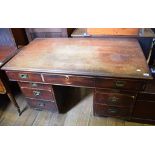 A late 19th/early 20th century mahogany and pine pedestal desk, having an arrangement of nine