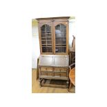 An oak bureau bookcase, 88 cm wide, a dining table, four chairs, a side cabinet and an occasional