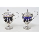 A pair of 19th century French silver mustard pots, crested and initialled, of vase form, with blue