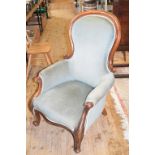 A Victorian mahogany spoon back armchair, on cabriole front legs with knurl feet