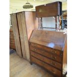 An oak bureau, 100 cm wide, a Victorian mahogany tea table, with fold out top, on square tapering