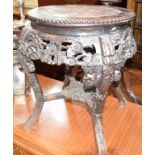 A Chinese hardwood jardiniere stand, with a marble inset top, carved flowers and foliage, 48 cm