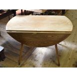 An Ercol beech and elm drop leaf table, 123 cm wide, and a pair of similar kitchen chairs (3) Report