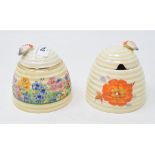 A Clarice Cliff Pansies pattern honey pot and cover, 9.5 cm high, and another, Radiant pattern, chip