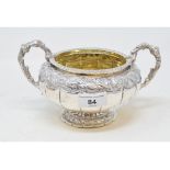 A silver two handled sugar bowl, with embossed decoration, London 1824, approx. 13.5 ozt 11.5 cm