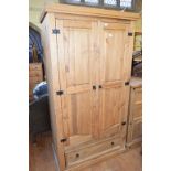 A pine wardrobe, with a single drawer to the base, 103 cm wide, and a matching chest of drawers (2)