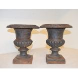 A pair of cast iron jardiniere stands, 26 cm high (2)
