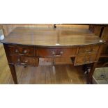 A mahogany bow front dressing table or sideboard, having an arrangement of five drawers on square
