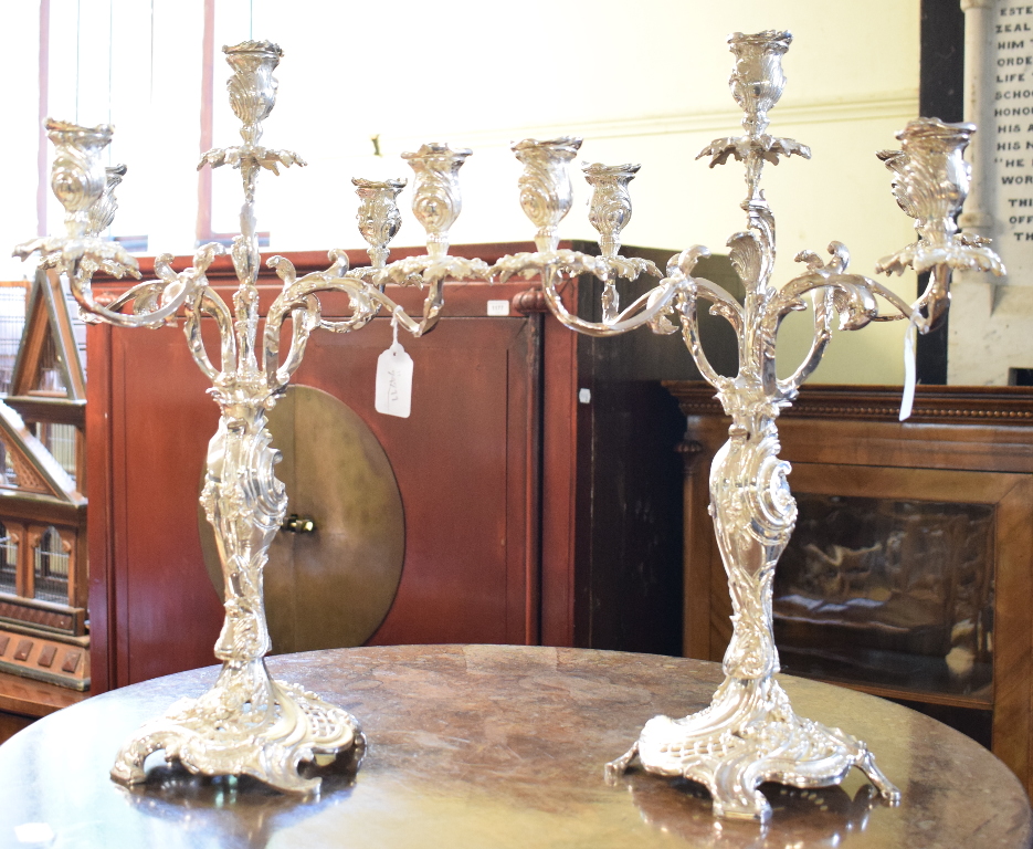 A pair of plated rococo style five light candelabra, 48 cm high (2) Report by RB Modern
