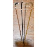 A walking cane, with a metal dog head handle, and three other walking sticks (4)