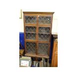 An oak four section Minty style bookcase, with leaded glass doors, 93.5 cm wide