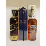 A bottle of Johnnie Walker Blue Label whisky, a bottle of Johnnie Walker Black Label whisky, and a
