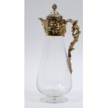 A Victorian glass claret jug, with silver gilt mounts decorated fruit and foliage, and with a