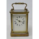 A carriage timepiece, the enamel dial with Roman numerals, in a brass four pillar case, 14 cm high