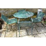 A 1950s metal garden table, 96 cm diameter and four matching chairs (5)