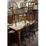 A set of eight elm wheelback kitchen dining chairs (6 + 2), other chairs and a pine dining table (