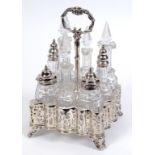 A Victorian silver and cut glass eight piece cruet, crested, of shaped outline, with pierced