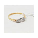 An 18ct gold and three stone diamond ring, approx. ring size OÂ½ Report by NG Approx. 2.0 g (all in)