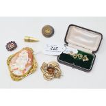 A 9ct gold, peridot and seed pearl bar brooch, a 19th century shell cameo brooch, a shield brooch,