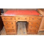 A late Victorian walnut pedestal desk, the leather inset top above an arrangement of nine drawers,