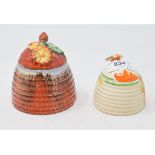 A Clarice Cliff honey pot and cover, with moulded cover and Delecia glaze, 9.5 cm high, and another,