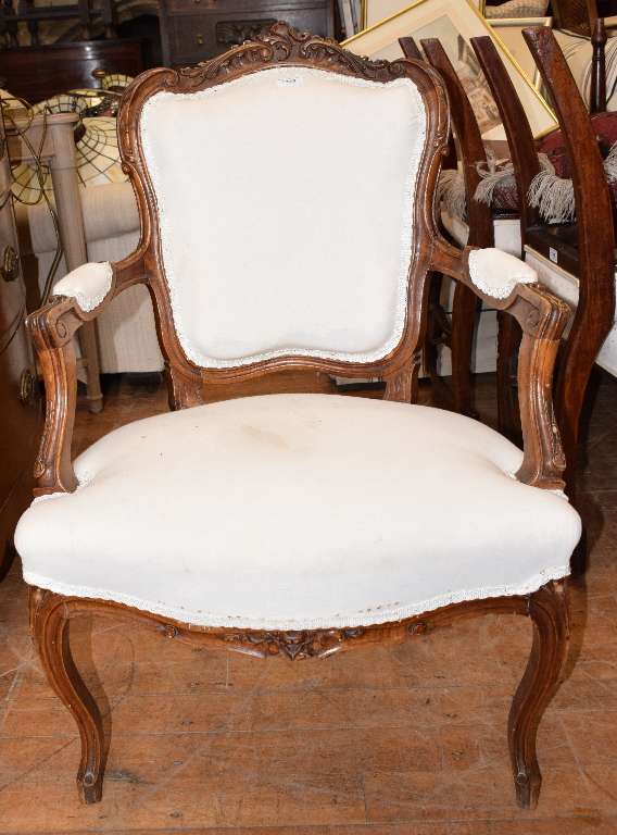 A Continental walnut armchair, with carved decoration, a set of four Regency dining chairs, two