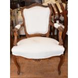A Continental walnut armchair, with carved decoration, a set of four Regency dining chairs, two