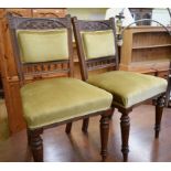 A set of six late Victorian mahogany dining chairs, with carved decoration, some lacking castors (6)