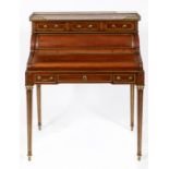 A Louis XVI style mahogany cylinder desk, the brass three quarter gallery above a marble top and