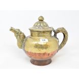 A Tibetan copper and brass teapot with embossed decoration, 26 cm high