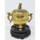 A Chinese polished bronze censer and cover, of slightly tapering ovoid form, the cover with a Dog of