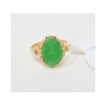 An oval jadeite ring, in a yellow coloured metal mount, approx. ring size JÂ½ Report by NG It is