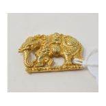 A yellow coloured metal elephant, with string loops to reverse Report by NG Approx. 3.0 g (all in)