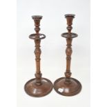 A pair of carved and turned wood candlesticks, 43 cm high (2)