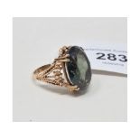 A 9ct gold and green stone dress ring, approx. ring size M Report by NG It is approx. 9.4 g (all in)