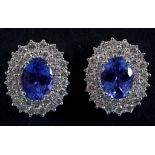 A pair of large 18ct white gold, oval tanzanite and diamond cluster stud earrings See illustration